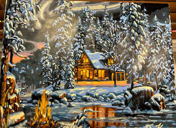 Aurora Bliss paint by numbers completed by Allan D: a lit cabin in snowy pines beside a campfire under the northern lights