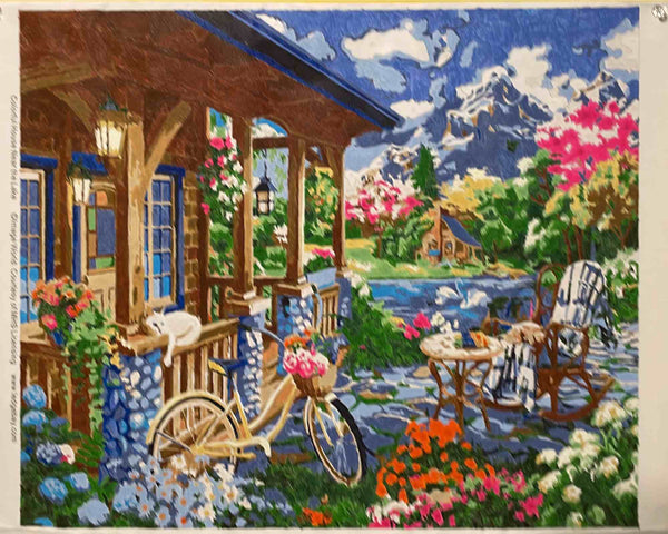 Colorful House Near the Lake paint by numbers completed by Kathleen M: a flower-filled porch above a mountain lake