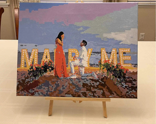 Custom paint by numbers made from Lilia S's own photo: a beach proposal, with MARRY ME spelled out on the shore