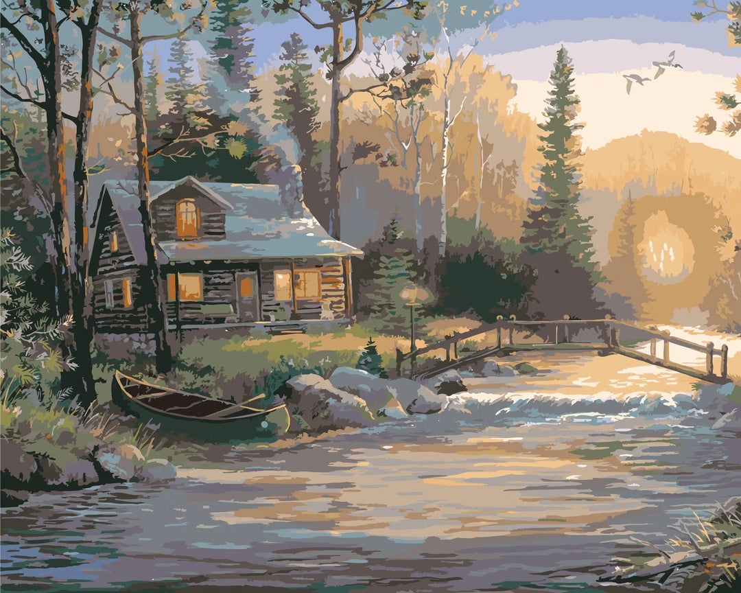 Paint by numbers canvas of a log cabin beside a woodland creek