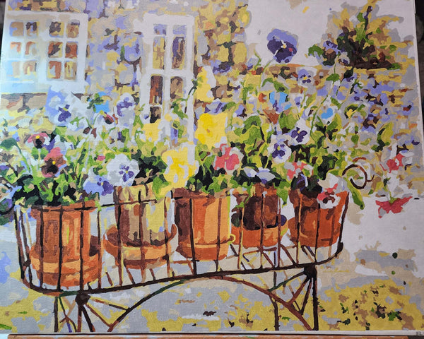 Rita's Pansies paint by numbers completed by Justina R: pansies in terracotta pots on a garden cart