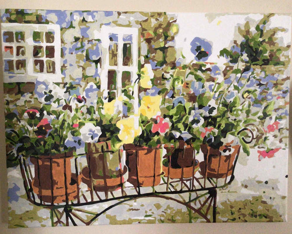 Rita's Pansies paint by numbers completed by Rosemarie: pansies in terracotta pots on a garden cart