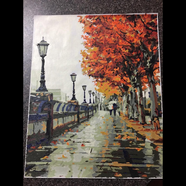 Paint by numbers completed by a customer: a wet autumn boardwalk lined with street lamps