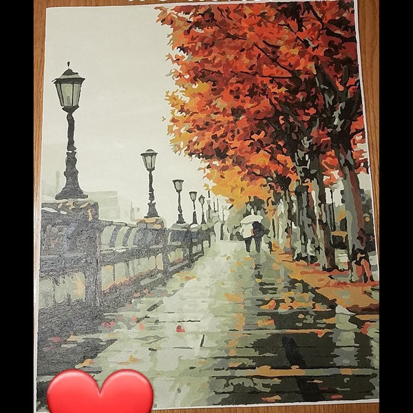 Paint by numbers completed by a customer: a rainy autumn street lined with lamps