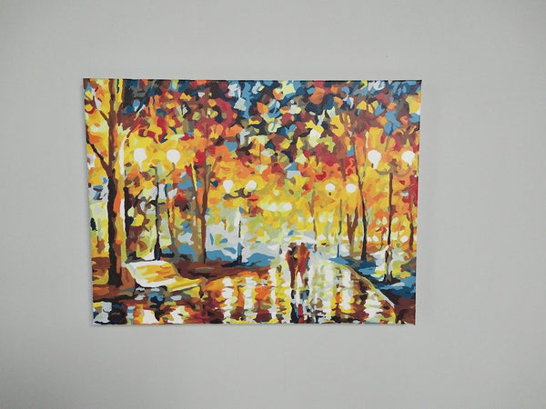 Paint by numbers completed by a customer: an autumn street lined with lamps, framed on a wall